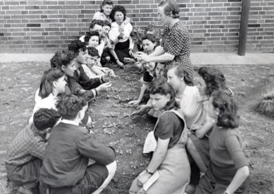 Young people being shown how to transplant seedlings in a JDC sponsored training class at the Bergen-Belsen DP camp.